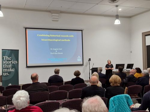 Angela Gurr presenting in front of a crowd