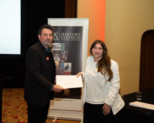 2026 Emerging Historian of the Year, Taylor Lupp, receiving her award from HCSA President, Prof. Matthew Fitzpatrick.
