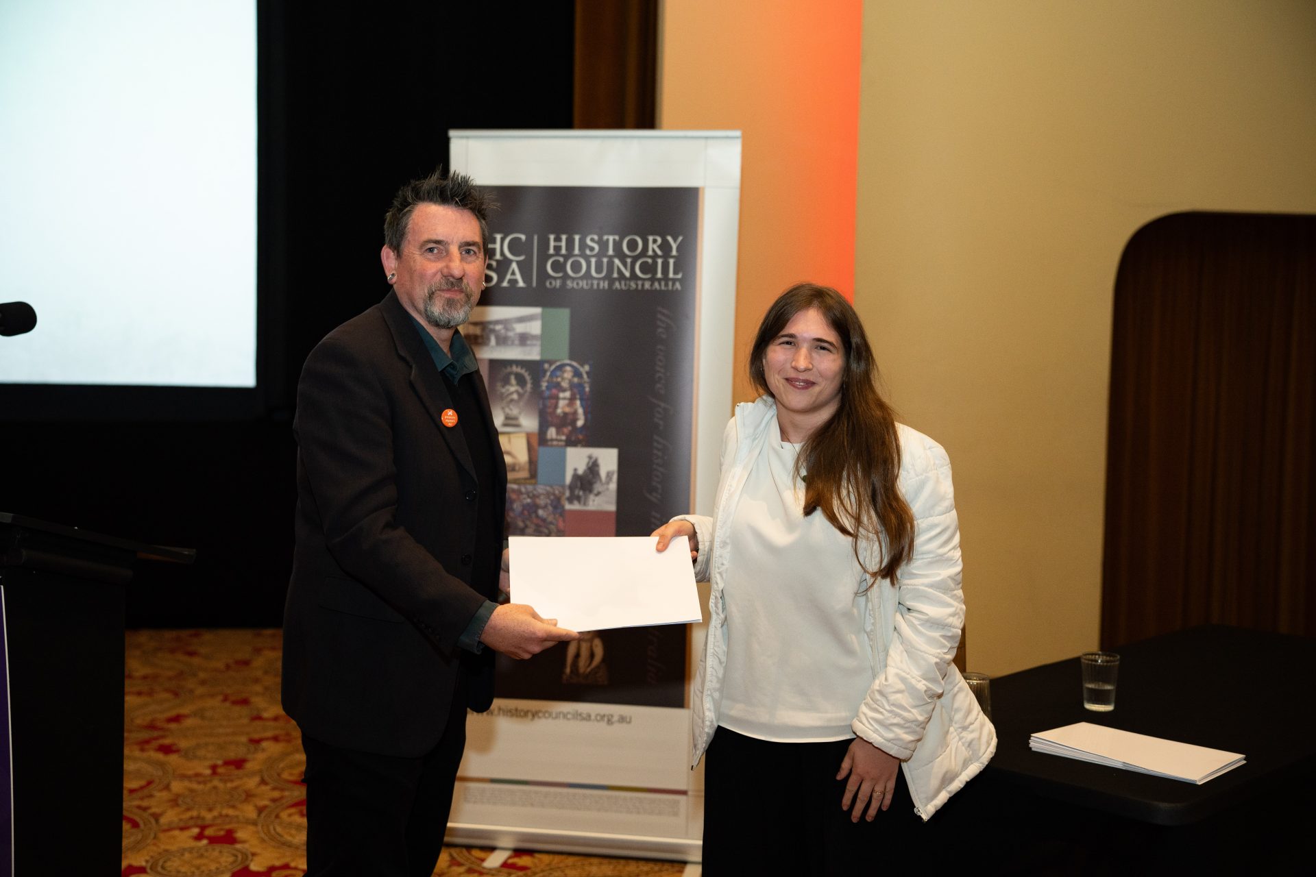 2026 Emerging Historian of the Year, Taylor Lupp, receiving her award from HCSA President, Prof. Matthew Fitzpatrick.