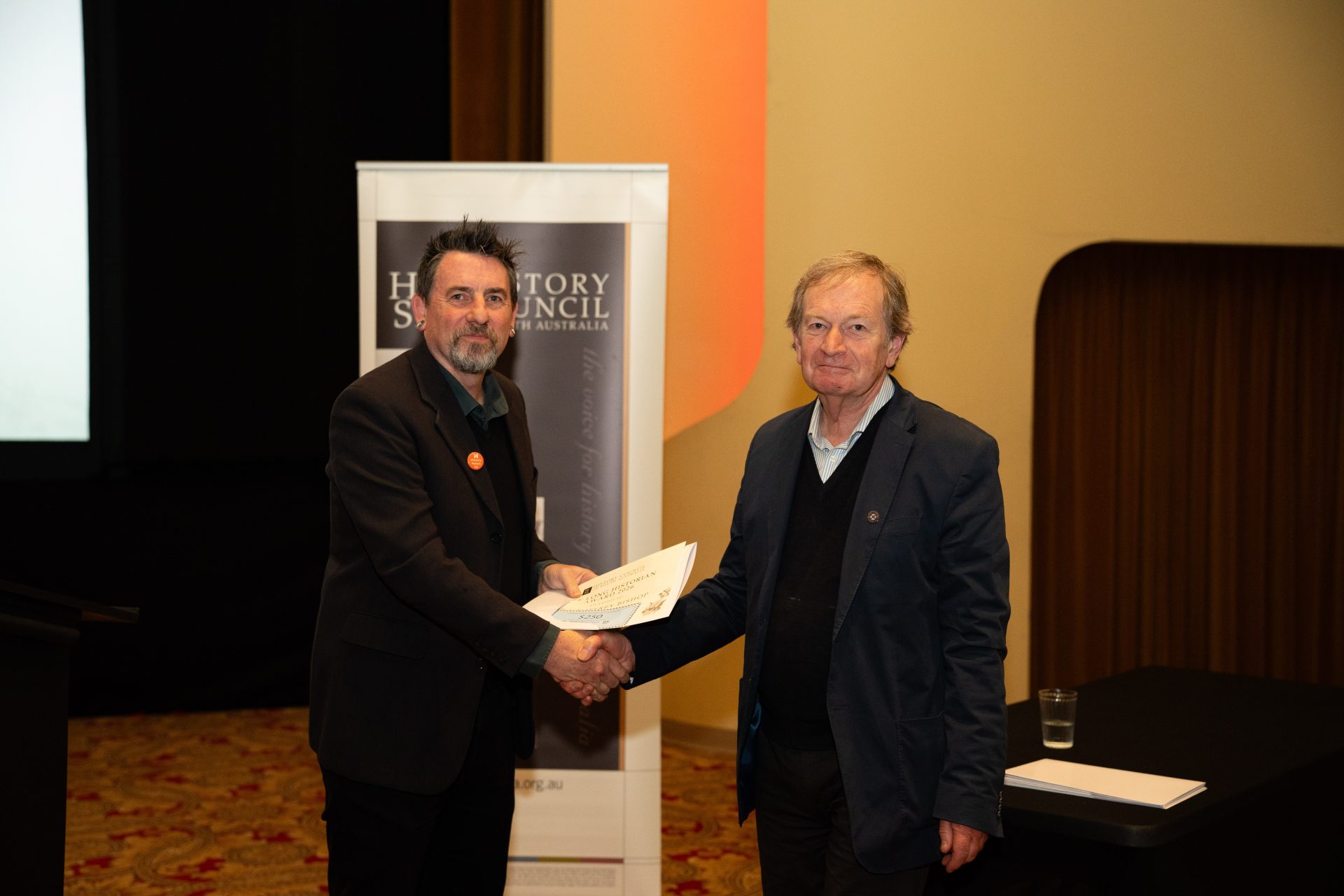 2026 Lifelong Historian Award winner, Dr Geoffrey Bishop, receiving his certificate from HCSA President, Prof. Matthew Fitzpatrick.