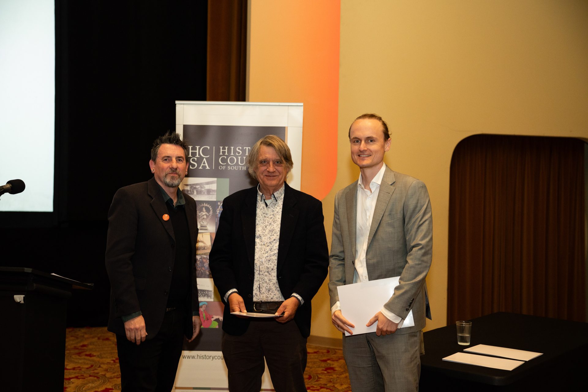 HCSA President Prof. Matthew Fitzpatrick, Michael Bollen of Wakefield Press, and winner of the 2026 Wakefield Press Essay Prize, Dr. Samuel Cox.